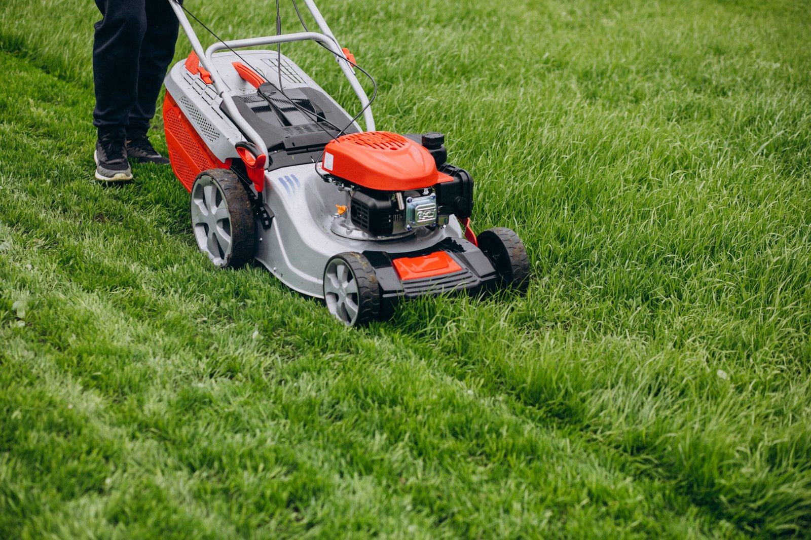 Lush green lawn with mower and fresh cut lines